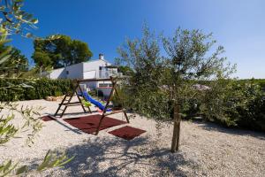 a playground with a tree and a swing at Casa Belladonna by Briskva in Višnjan