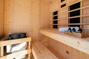 a wooden interior of a sauna with bottles on shelves at Casa Belladonna by Briskva in Višnjan +36 photos