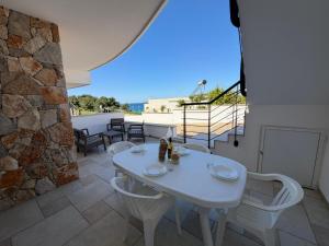 a white table and chairs on a patio at Casa Ca 'Luci in Marina San Gregorio