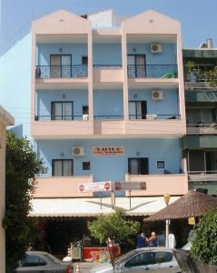 a large blue building with people standing outside of it at Kahlua Hotel Apartments in Rhodes Town