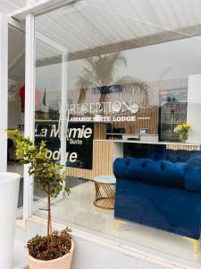 a blue couch in front of a store window at Lamamie Suite Lodge in Thohoyandou +61 photos
