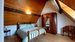 a bedroom with a bed and a wooden ceiling at Chalet chateau verdun in Château-Verdun