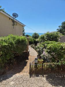 a path leading to a house with a fence at Westcliffe chalets channel view in Niton