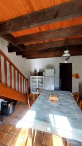 a dining room with a table and a kitchen at Chalet chateau verdun in Château-Verdun