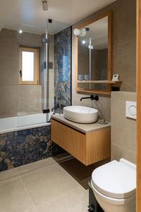 a bathroom with a sink and a toilet and a shower at La Parenthèse du Goûter - by Care Concierge in Les Houches +15 photos