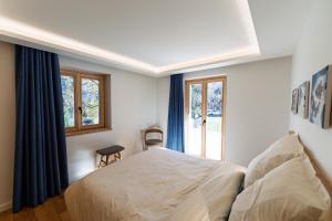 a bedroom with a bed and a window at La Parenthèse du Goûter - by Care Concierge in Les Houches