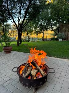 a fire pit filled with logs on a patio at Bridge View Hopetown in Hopetown