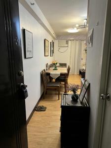 a room with a table and a dining room at Very Cozy Condo Davao in Davao City +1 photo