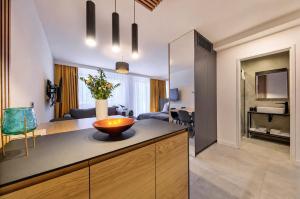 a kitchen and living room with a bowl on a counter at InPoint Central Apartments Old Town&Kazimierz - Free Parking in Krakow