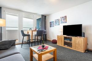 a living room with a couch and a flat screen tv at Nordseeblick in Bremerhaven