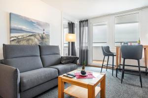 a living room with a couch and a table at Nordseeblick in Bremerhaven