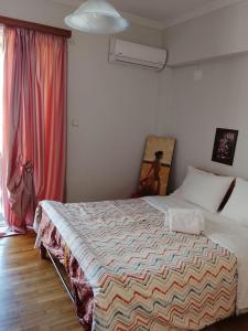 a bedroom with a bed and a window at Savelona's Guest Appartment in Agrinio