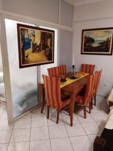 a dining room with a wooden table and chairs at Savelona's Guest Appartment in Agrinio