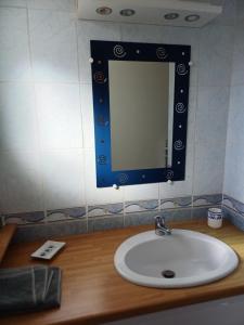 a bathroom sink with a mirror on a counter at maison 6 personnes in Locquirec