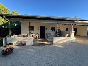 a house with a patio with a table and chairs at Bridge View Hopetown in Hopetown