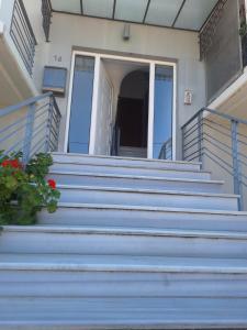 a front porch of a house with blue stairs at Dimitra's APARTMENT NAFPLIO in Nafplio +11 photos