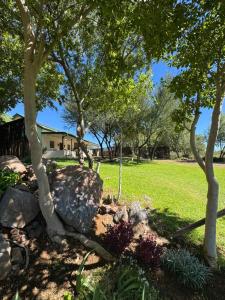 a garden with rocks and trees and a house at Bridge View Hopetown in Hopetown