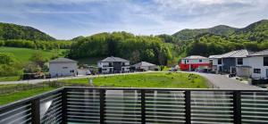 a view from a balcony of a village with a green field at Das Haus in Furth an der Triesting