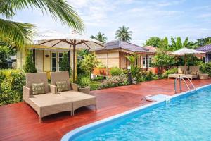 an image of a house with a swimming pool at Phetmanee Resort in Ko Yao Noi