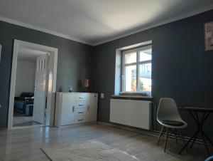 a room with a white cabinet and a window at Ewula in Giżycko +4 photos