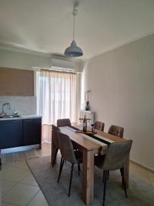 a dining room with a wooden table and chairs at Dimitra's APARTMENT NAFPLIO in Nafplio