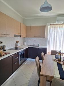 a kitchen with a table and a dining room at Dimitra's APARTMENT NAFPLIO in Nafplio