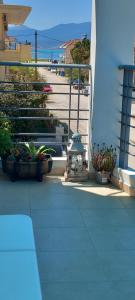 a balcony with potted plants on a building at Dimitra's APARTMENT NAFPLIO in Nafplio