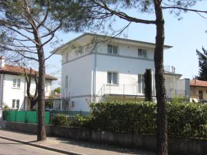 a white house with trees in front of it at alla Gledizia in Udine