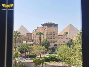 a view of the pyramids from a window of a building at Zak Pyramids Inn in Cairo