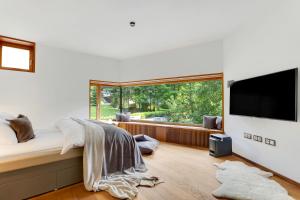 a bedroom with a bed and a large window at Villa Jasna in Kranjska Gora +40 photos