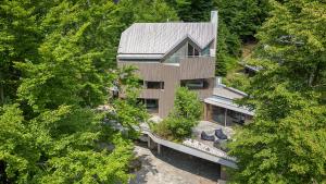 an overhead view of a house with trees at Villa Jasna in Kranjska Gora