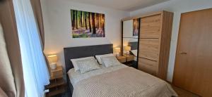 a bedroom with a bed and a painting on the wall at Monte Symphony in Rakovica