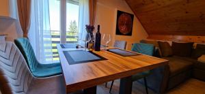 a living room with a wooden table with wine glasses at Monte Symphony in Rakovica