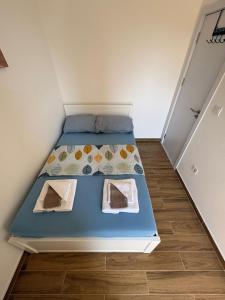 a small bedroom with a bed in a room at Ivanovica in Đenovići