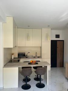 a kitchen with a table and two bar stools at Ivanovica in Đenovići