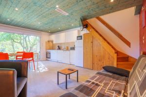 a living room with a couch and a table at Mas du soleil levant in Les Vans