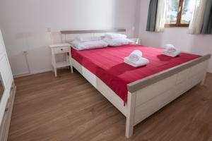 a bedroom with a large bed with towels on it at La Casetta di Gio in Pula