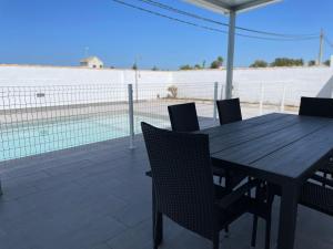 a wooden table and chairs with a view of the beach at Casa Miamar I in Campano +13 photos