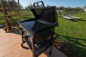 a black barbecue grill sitting on a patio at La Casetta di Gio in Pula