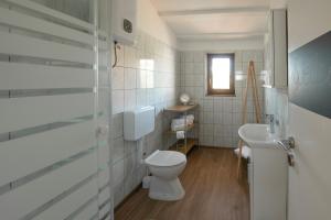 a bathroom with a toilet and a sink at La Casetta di Gio in Pula +16 photos
