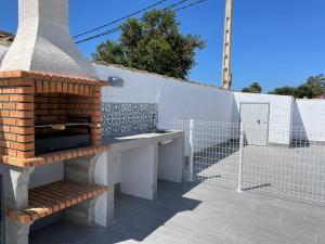 a brick oven sitting on top of a patio at Casa Miamar I in Campano