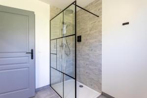 a shower with glass doors in a bathroom at Maison Lahourcade in Lahourcade +15 photos