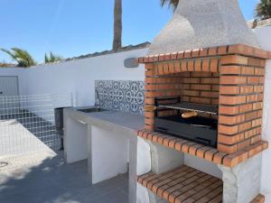 a brick oven sitting on top of a patio at Casa Miamar II in Campano +10 photos