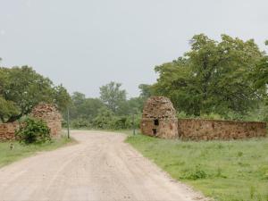 an old stone wall on a dirt road at Buffalo Tented Camps in Mahango