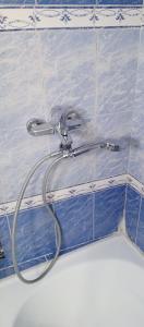 a shower hose is attached to a blue tile wall at Chambre single de Luxe in Kasbah +22 photos