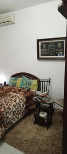 a bedroom with a bed with a table next to it at Chambre single de Luxe in Kasbah