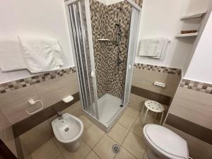 a bathroom with a shower and a toilet and a sink at Hotel Germania in Praia a Mare +35 photos