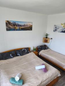 a bedroom with two beds with towels on them at Furó Vendégház in Fülöp +79 photos