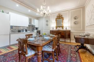 a dining room with a wooden table and chairs at GuestHost - Chic Central Apartment in Montecatini in Montecatini Terme