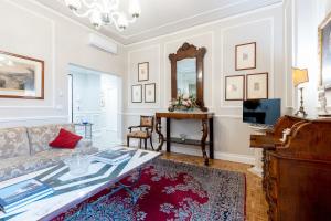 a living room with a couch and a mirror at GuestHost - Chic Central Apartment in Montecatini in Montecatini Terme